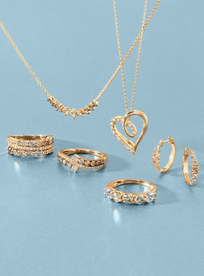 Desert Diamonds Gold Jewelry Collection Gold and ombre round diamond chain, chain with heart pendant, rings, and classic huggies earrings